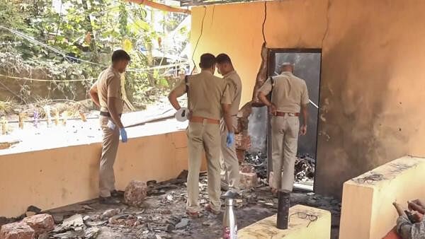 <div class="paragraphs"><p>Police inspect the fire accident spot at the Anjootambalam Veererkavu Temple at Neeleswaram in Kasaragod district</p></div>