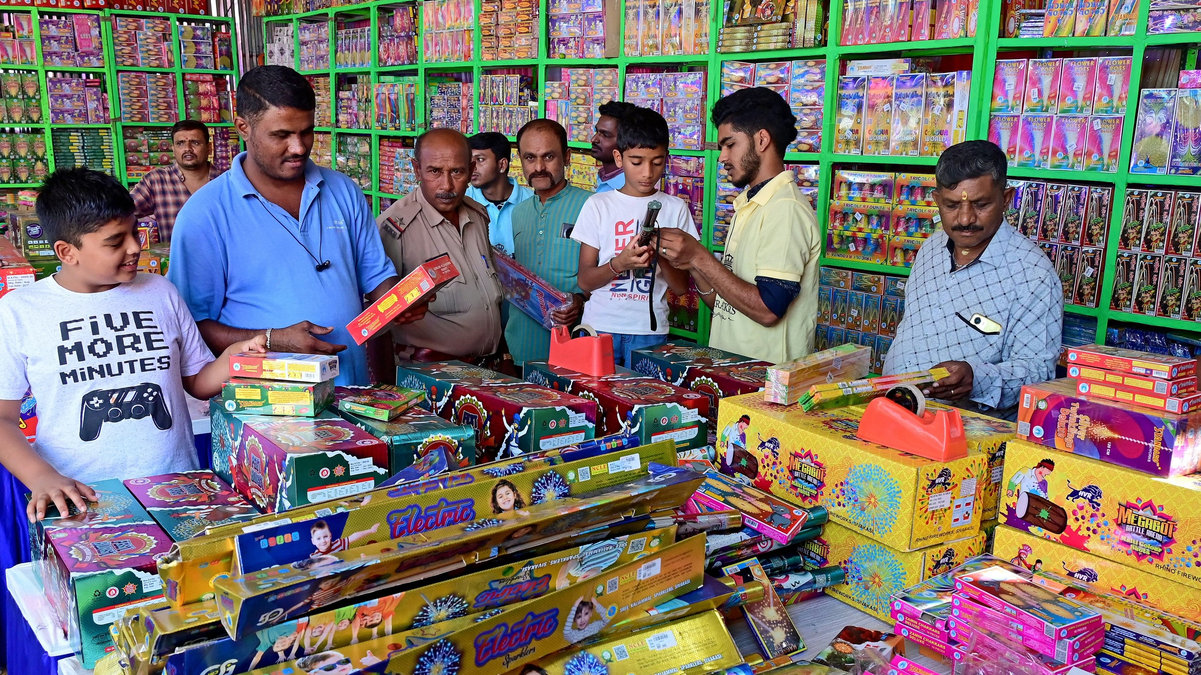 <div class="paragraphs"><p>People buy crackers at the Udayabhanu Kala Sangha playground at Basavanagudi ahead of Deepavali, on Tuesday. </p></div>