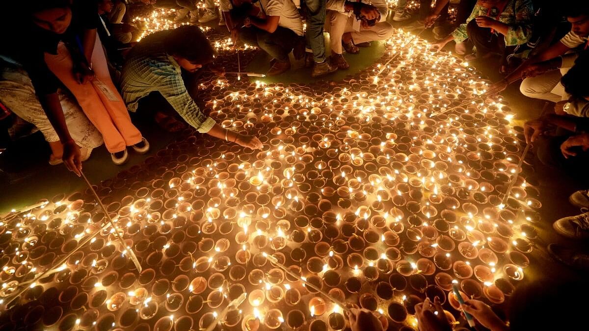 <div class="paragraphs"><p>Devotees light ‘diyas’ (earthen lamps) at the ‘Ram ki Paidi’ during ‘Deepotsav 2024’ on the eve of the Diwali festival, in Ayodhya, Wednesday, Oct. 30, 2024.</p></div>