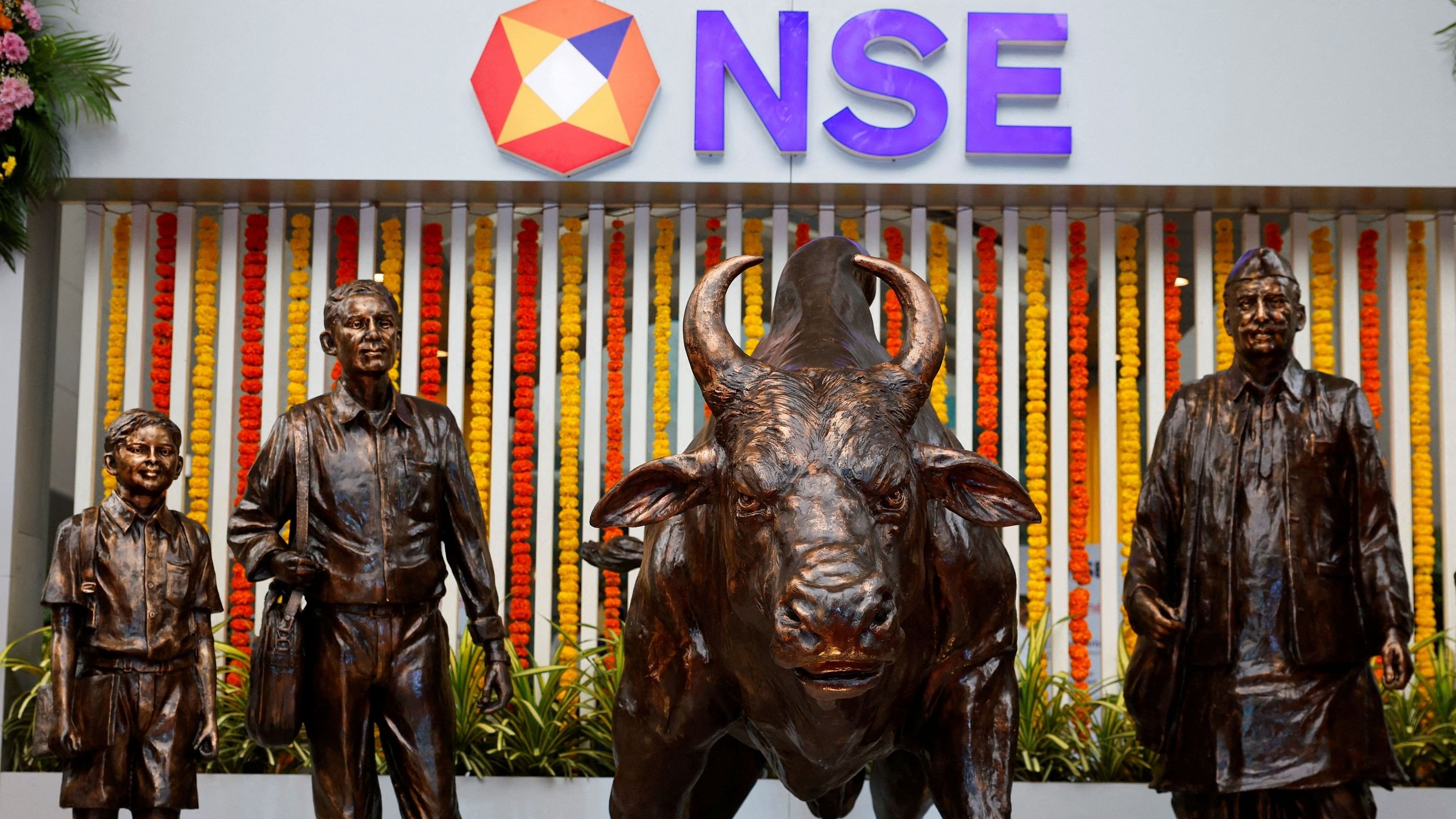 <div class="paragraphs"><p> Statues of people and a bull are seen next to the logo of the National Stock Exchange  in Mumbai, India.</p></div>