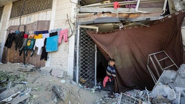 <div class="paragraphs"><p>A displaced Palestinian boy stands outside a damaged store where he shelters with his family who fled northern Gaza due to an Israeli military operation, shelter in a school in Gaza City.</p></div>