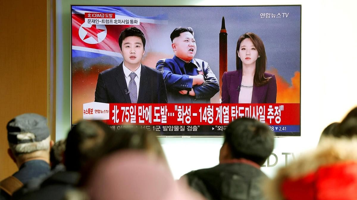 <div class="paragraphs"><p>People watch a TV broadcasting a news report on North Korea firing an intercontinental ballistic missile (ICBM).</p></div>