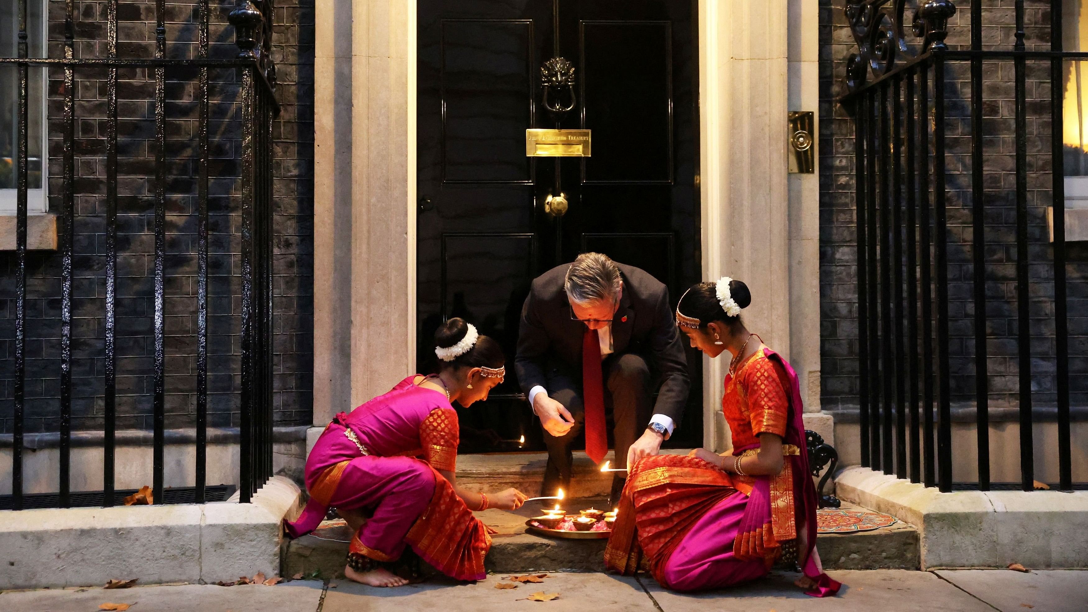 <div class="paragraphs"><p>Britain's Prime Minister Keir Starmer and members of the ​﻿​Arunima Kumar Dance Company light candles at the doorstep of 10 Downing Street during a reception to celebrate Diwali in London, Britain, October 29, 2024. </p></div>