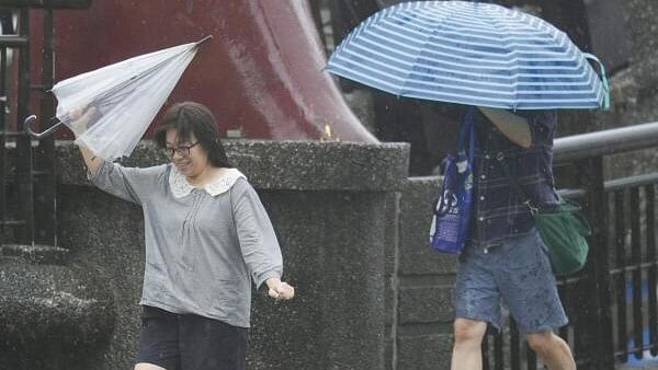 <div class="paragraphs"><p>People hold umbrellas as Typhoon Kong-rey approaches in Keelung, Taiwan.&nbsp;</p></div>