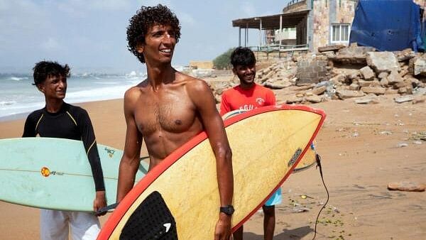 <div class="paragraphs"><p>Attiq Ur Rehman, 21, walks with his teammates along the beach as they prepare to surf at Turtle Beach in Karachi, Pakistan.&nbsp;</p></div>