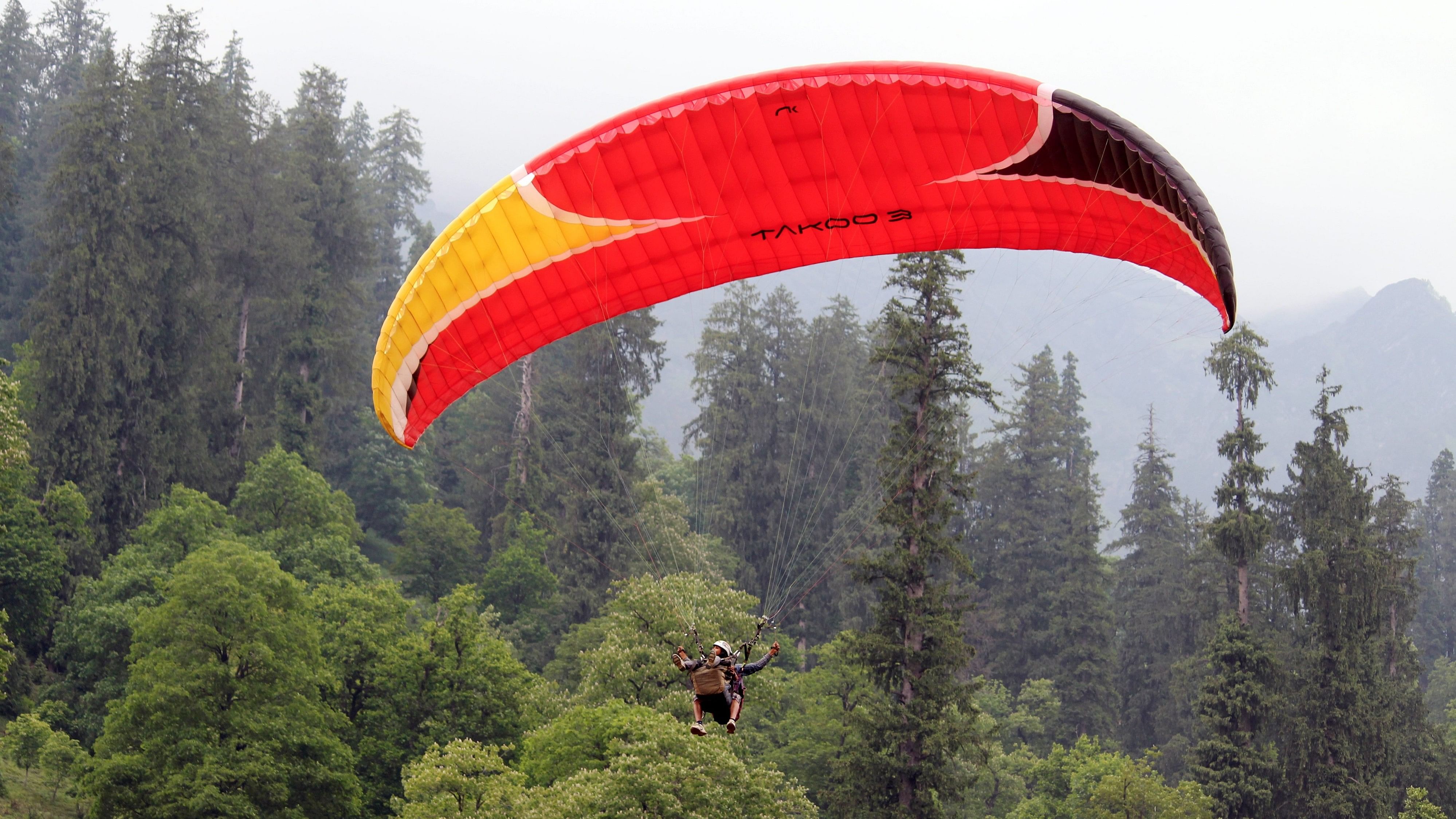 <div class="paragraphs"><p>File Photo: A tourist does paragliding at Solang Nullah, in Manali.</p></div>