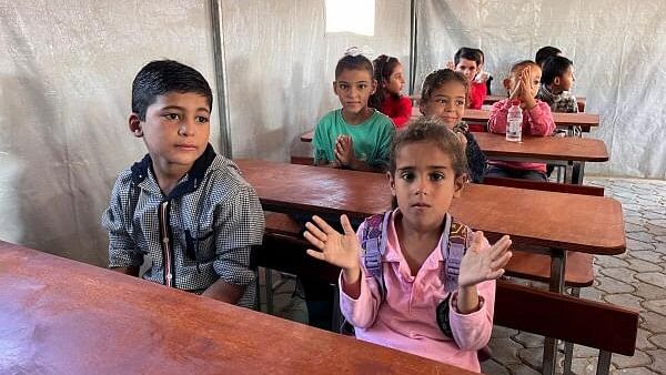 <div class="paragraphs"><p>Palestinian children attend a class in a makeshift school in Khan Younis in the southern Gaza Strip.</p></div>