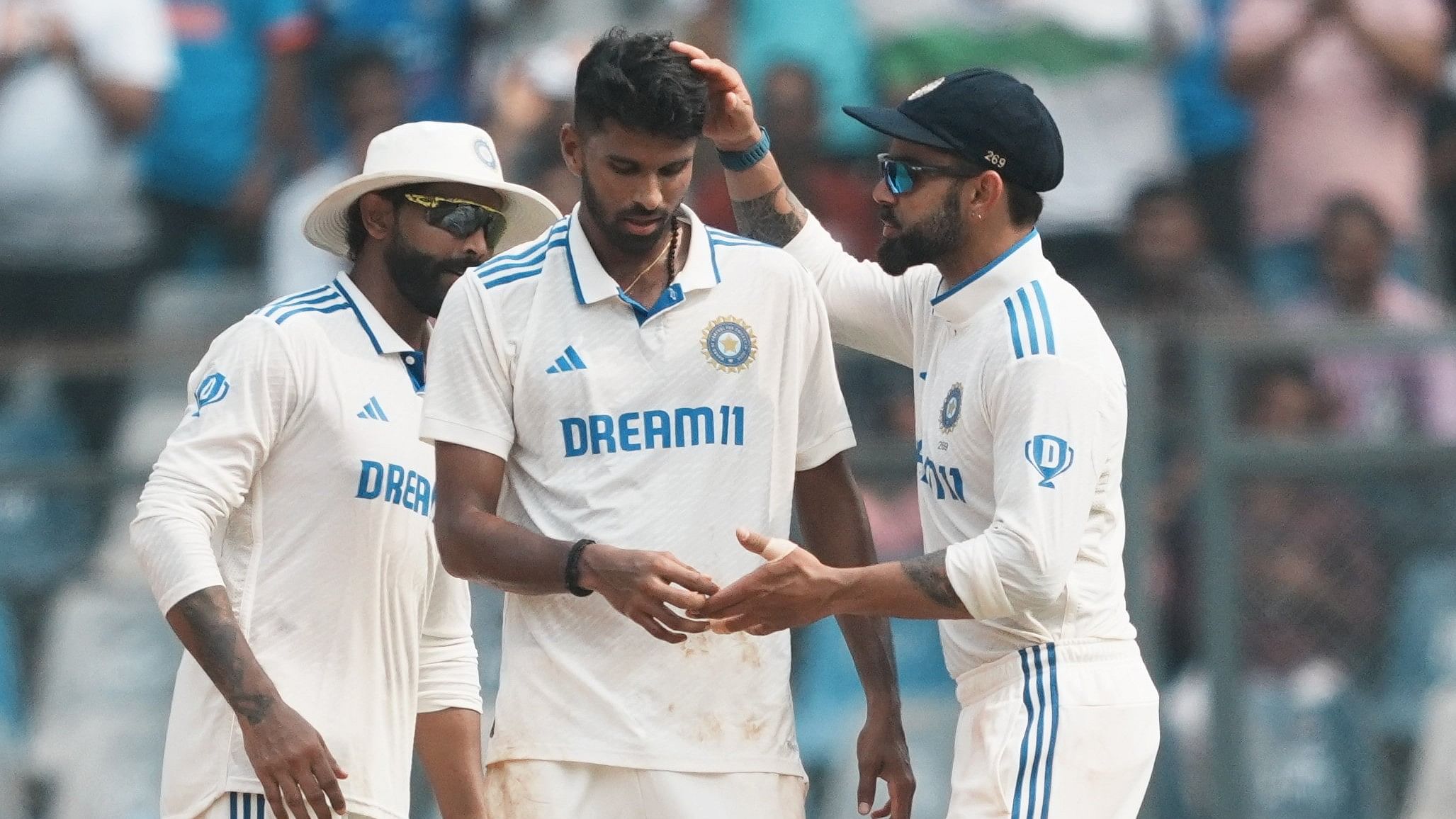 <div class="paragraphs"><p>India's bowler Washington Sundar with teammates Virat Kohli and Ravindra Jadeja celebrates the wicket of New Zealand's batter Tom Latham during the first day of the third Test cricket match between India and New Zealand.</p></div>