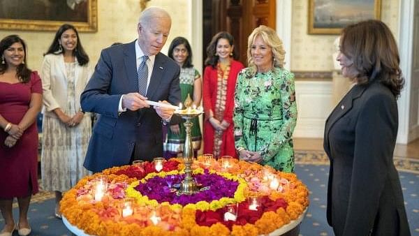 <div class="paragraphs"><p>United States President Joe Biden lights a lamp as First lady Jill Biden and Vice President Kamala Harris look on during an event to celebrate Diwali, at the White House in Washington, US in 2022.</p></div>