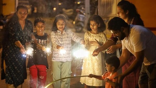 <div class="paragraphs"><p>Families and kids celebrate Deepawali by lighting firecrackers at Ullal, Bengaluru on Thursday.</p></div>