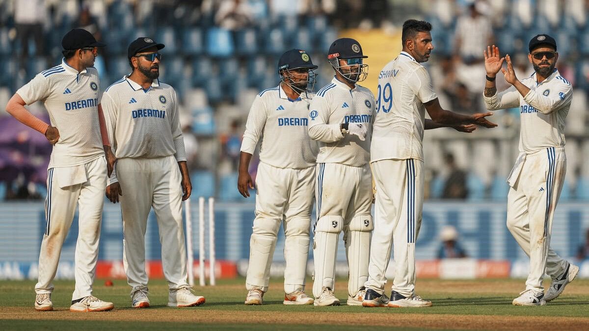 <div class="paragraphs"><p>Ravichandran Ashwin celebrates with teammates after taking the wicket of New Zealand's Glenn Phillips on the second day of the third test cricket match between India and New Zealand, at the Wankhede Stadium, in Mumbai, Saturday, November 2, 2024.</p></div>