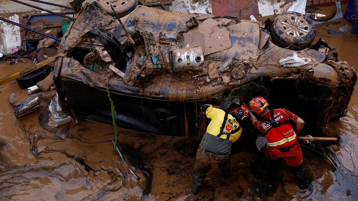 <div class="paragraphs"><p>Firefighters search for possible victims inside a car damaged following heavy rains that caused floods, in Alfafar, Valencia, Spain, November 1, 2024.</p></div>