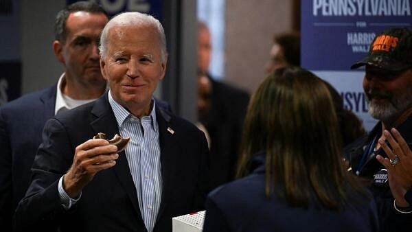 <div class="paragraphs"><p>US President Joe Biden eats a donut as he visits his childhood hometown of Scranton, Pennsylvania, US.</p></div>