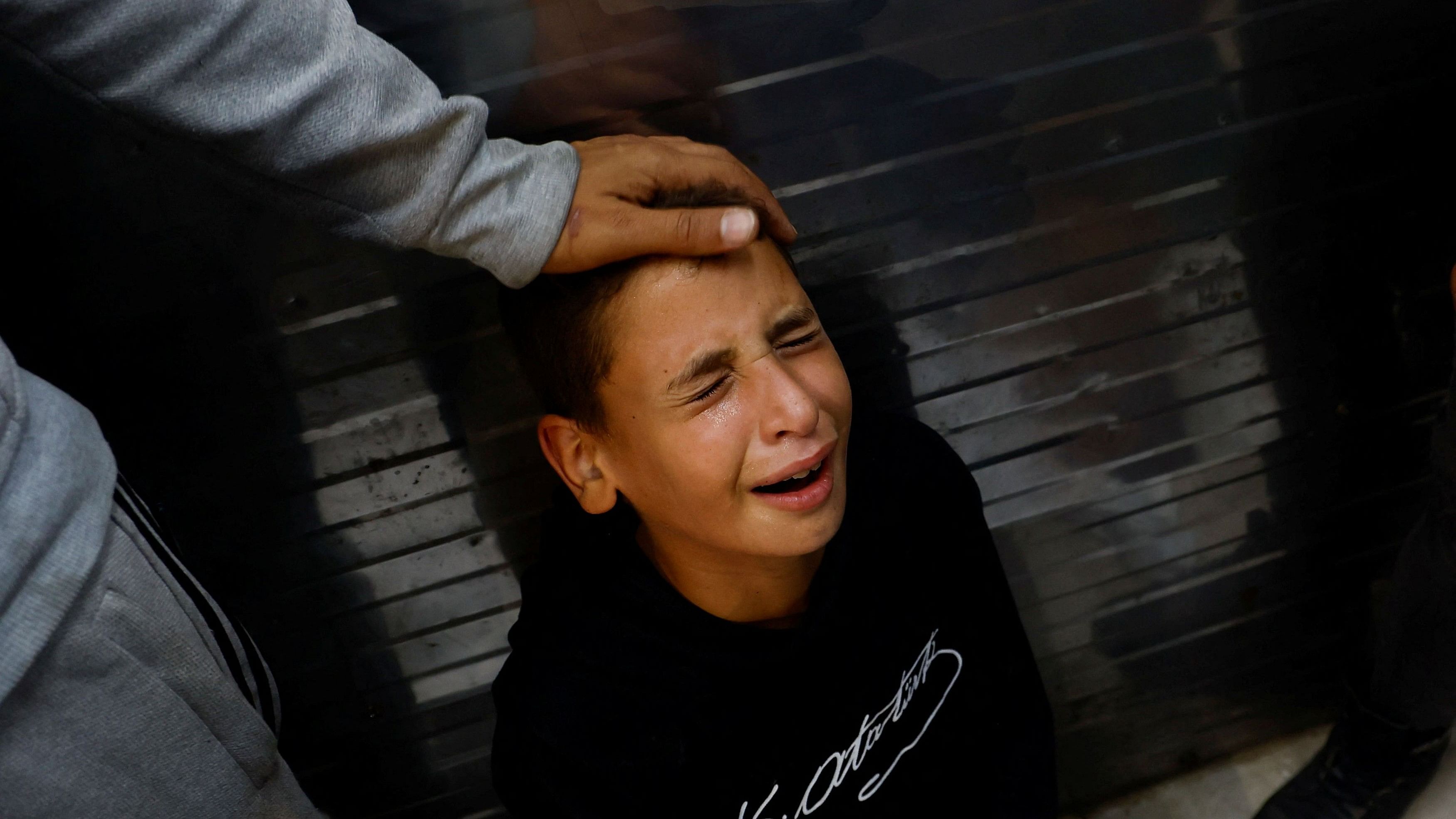 <div class="paragraphs"><p>A boy reacts as people mourn Palestinian children killed in Israeli strikes, amid the Israel-Hamas conflict, in Khan Younis in the southern Gaza Strip, November 3, 2024.</p></div>