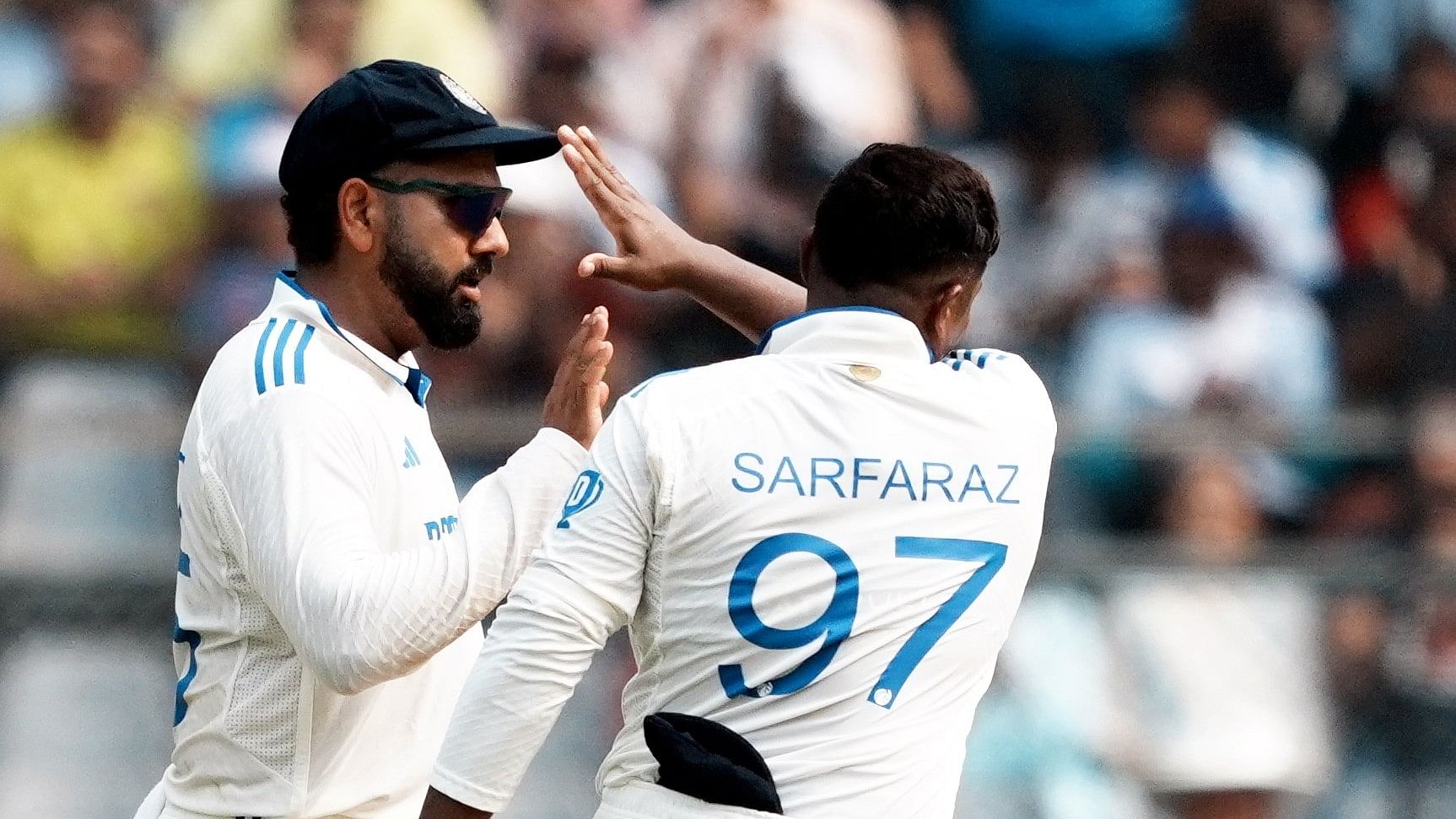 <div class="paragraphs"><p>Mumbai: India's captain Rohit Sharma with teammate Sarfaraz Khan celebrates the wicket of New Zealand's batter Tom Latham during the first day of the third Test cricket match between India and New Zealand, at Wankhede Stadium, in Mumbai, Friday, Nov. 1, 2024. </p></div>