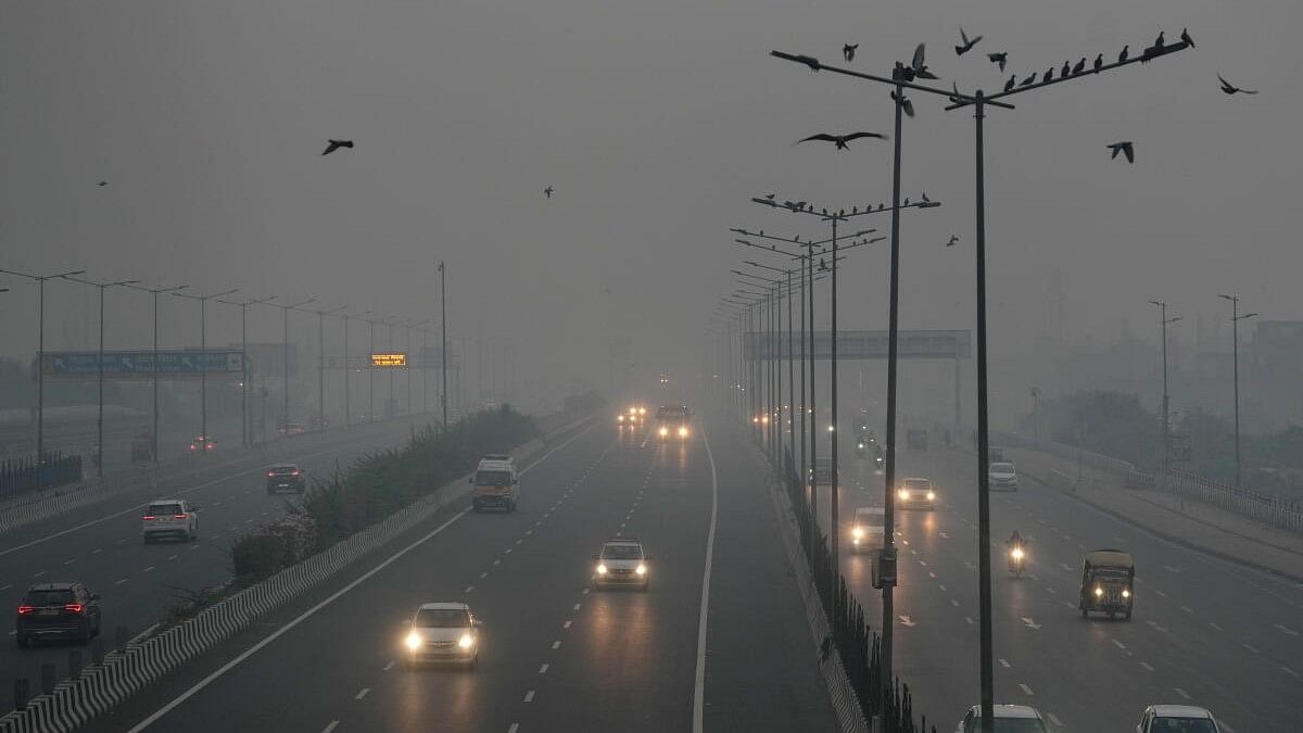 <div class="paragraphs"><p>Vehicles move on a road amid low visibility due to smog, a day after Diwali festival celebrations, in New Delhi.</p></div>