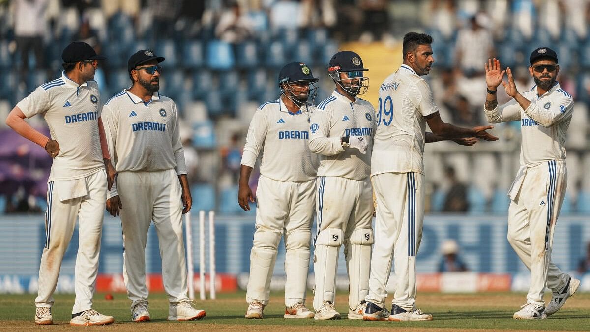 <div class="paragraphs"><p>a's Ravichandran Ashwin celebrates with teammates after taking the wicket of New Zealand's Glenn Phillips.</p></div>