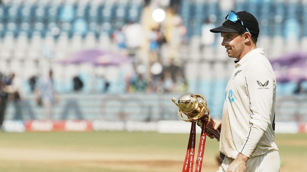 <div class="paragraphs"><p>New Zealand's captain Tom Latham poses with the trophy after winnng the third Test cricket match against India at Wankhede Stadium, in Mumbai.</p></div>