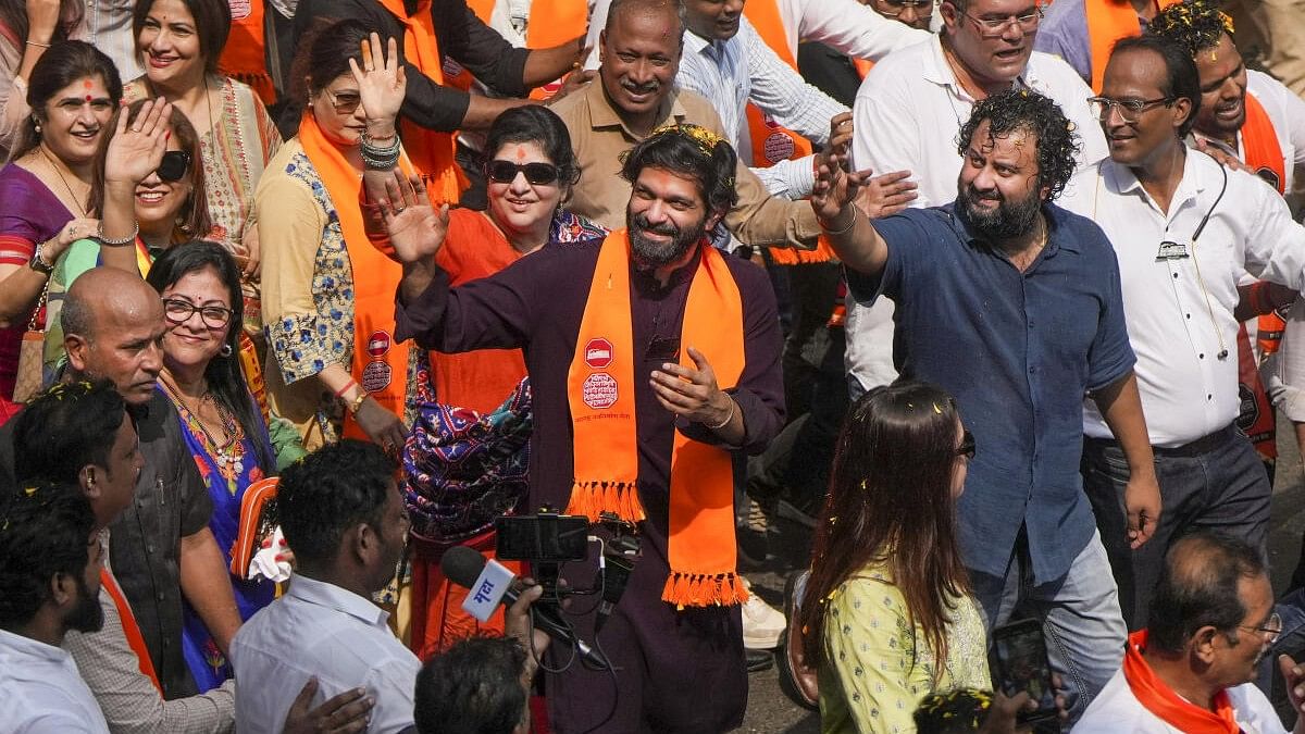 <div class="paragraphs"><p>MNS candidate Amit Thackeray, who is the son of party chief Raj Thackeray, gestures during a rally file his nomination papers from Mahim.&nbsp;</p></div>