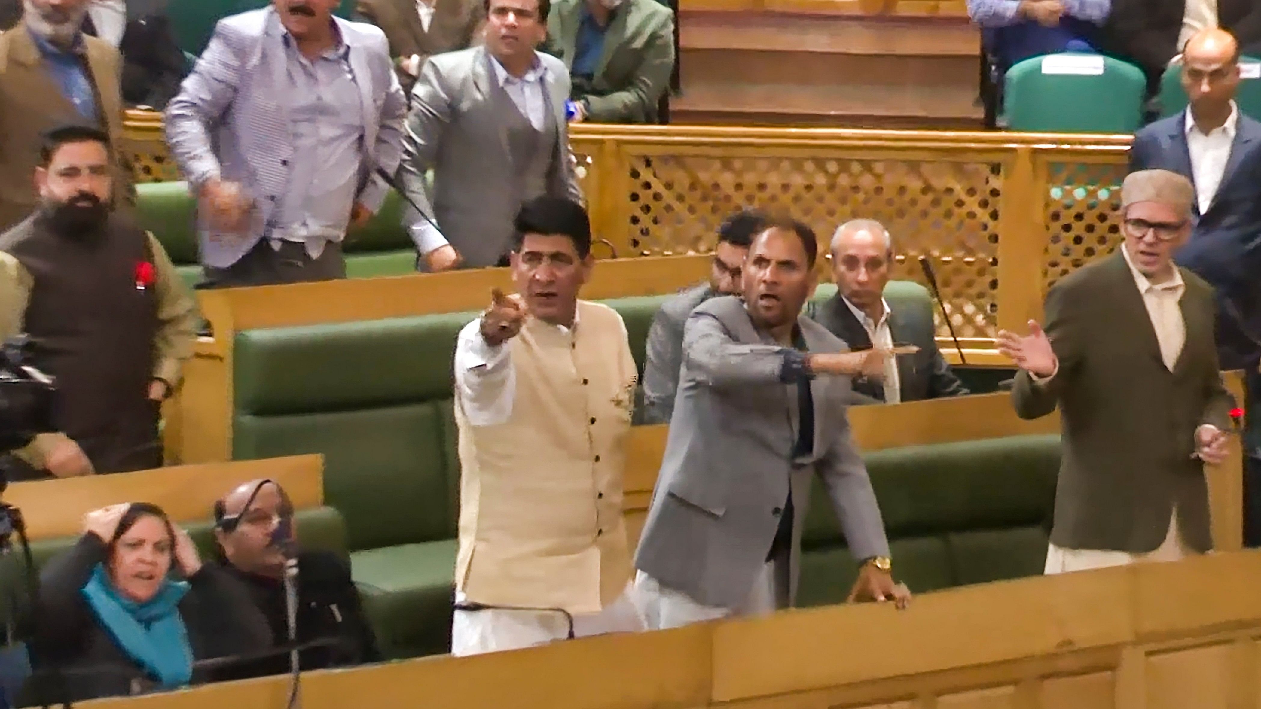 <div class="paragraphs"><p>Jammu and Kashmir Chief Minister Omar Abdullah (R) with others reacts in the Assembly during ruckus erupted after PDP MLA Waheed Para introduced a resolution opposing the abrogation of Article 370.&nbsp;</p></div>