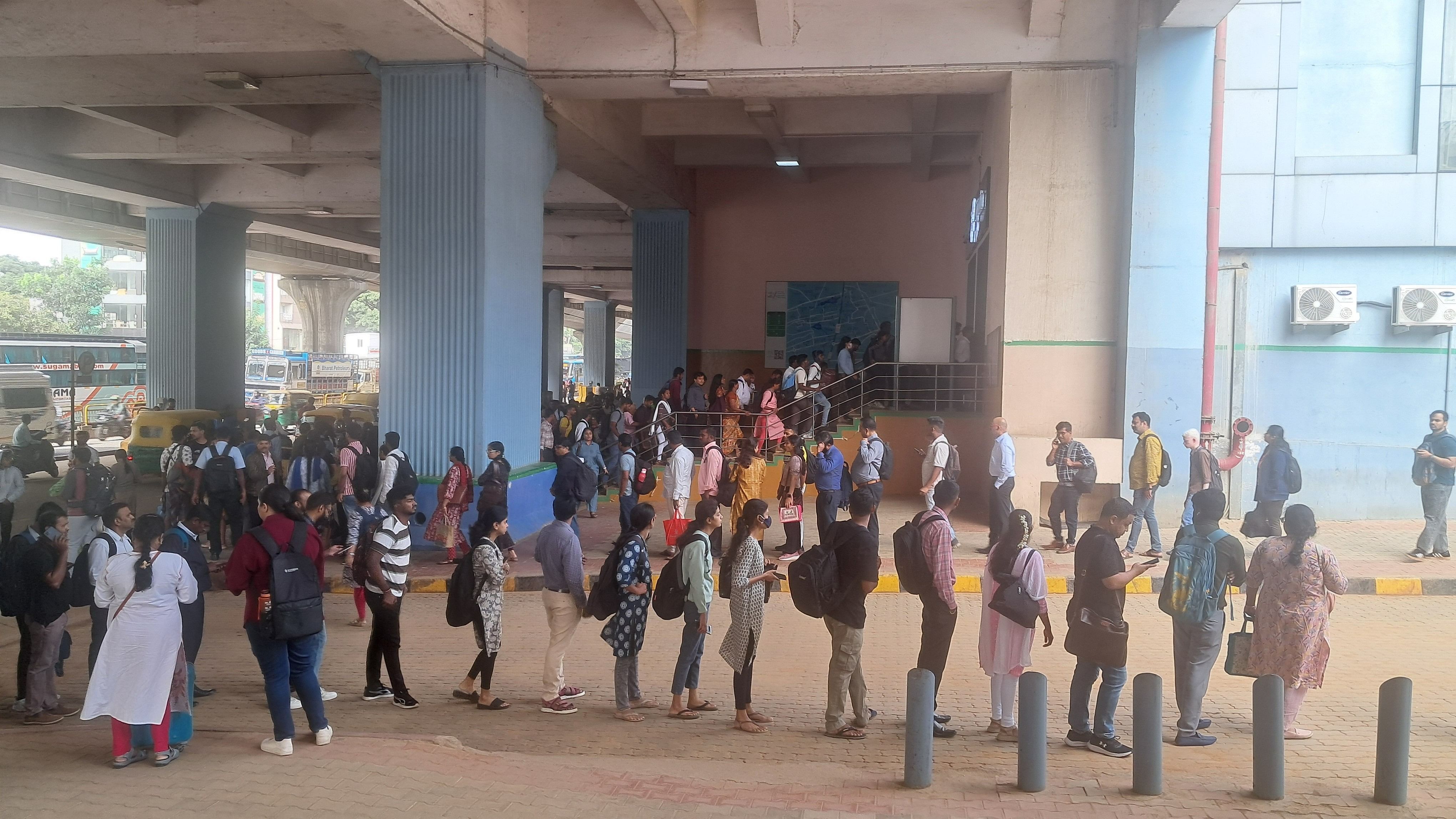 <div class="paragraphs"><p>People stand in long queues in front of the Nagasandra metro station on Monday. The queues stretched at least 500 metres from the station. </p></div>