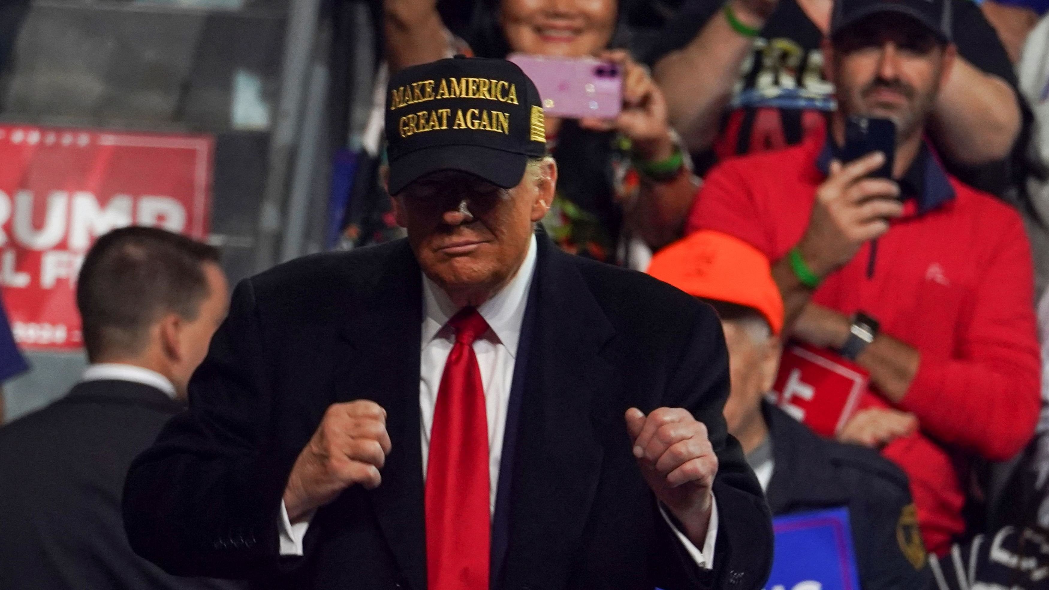 <div class="paragraphs"><p>Republican presidential nominee and former US President Donald Trump gestures at a rally at Atrium Health Amphitheater in Macon, Georgia</p></div>