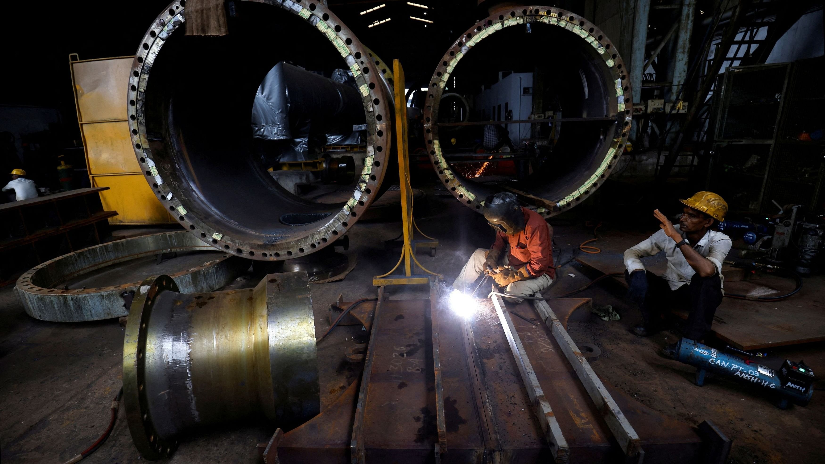 <div class="paragraphs"><p>A worker welds a cooling coil plate inside an industrial manufacturing unit on the outskirts of Ahmedabad</p></div>