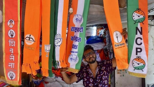 <div class="paragraphs"><p>A man arranges scarves of political parties at a shop, ahead of Maharashtra Assembly elections, in Mumbai.</p></div>