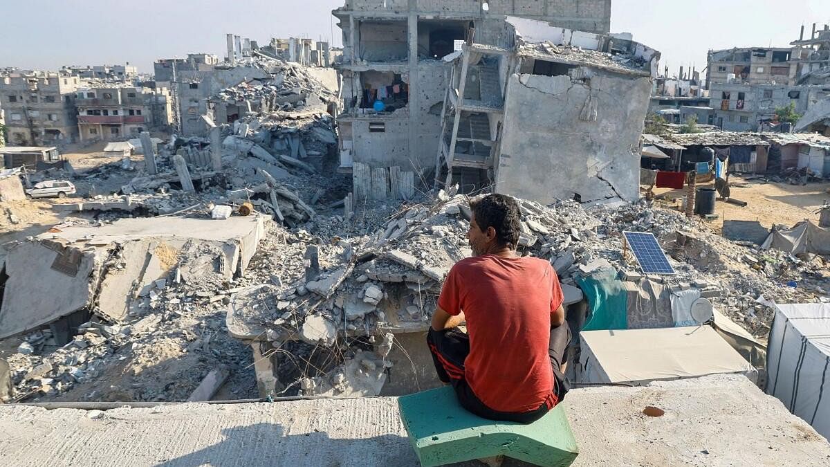 <div class="paragraphs"><p>A Palestinian man sits on the rubble of a house destroyed in the Israeli military offensive.</p></div>