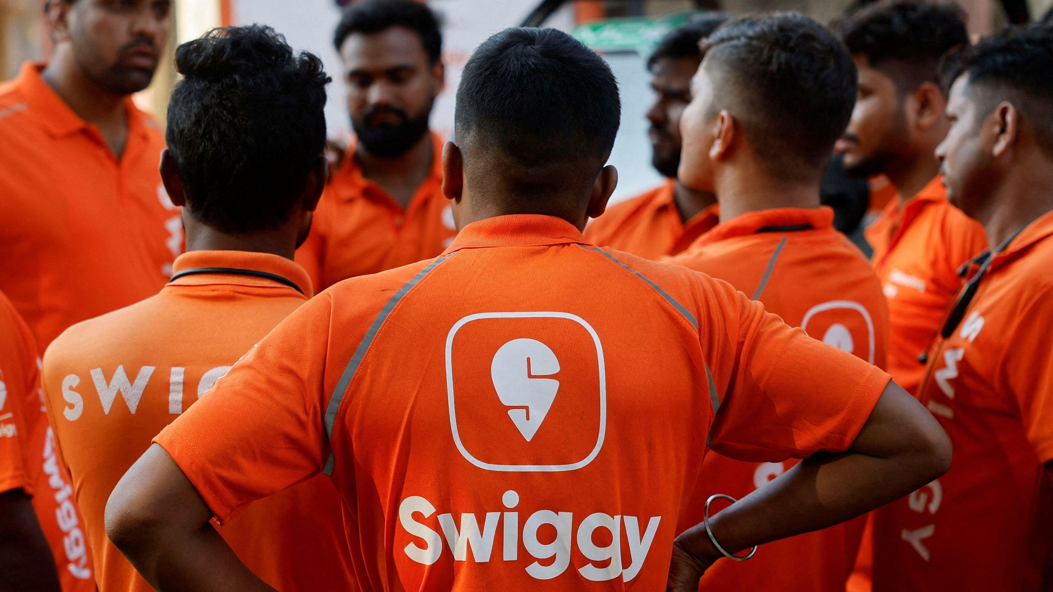 <div class="paragraphs"><p> Swiggy gig workers listen to a briefing during a promotional event in Mumbai.</p></div>