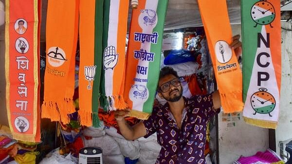 <div class="paragraphs"><p>A man arranges scarves of political parties at a shop, ahead of Maharashtra Assembly elections, in Mumbai.</p></div>