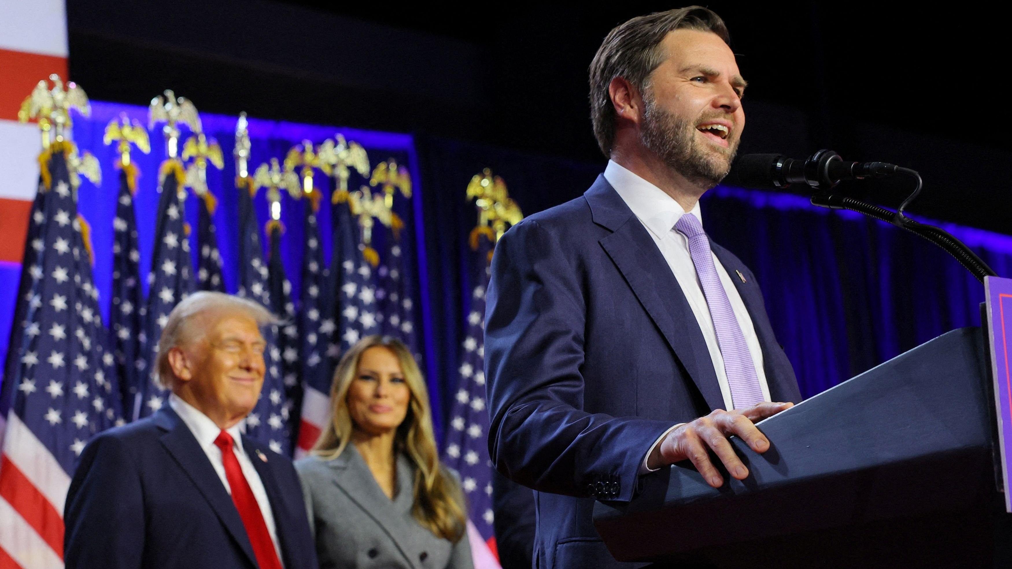 <div class="paragraphs"><p>Republican vice presidential nominee JD Vance speaks as Republican presidential nominee and former U.S. President Donald Trump and his wife Melania watch as he addresses supporters at Trump's rally, at the Palm Beach County Convention Center in West Palm Beach, Florida, U.S., November 6, 2024. </p></div>