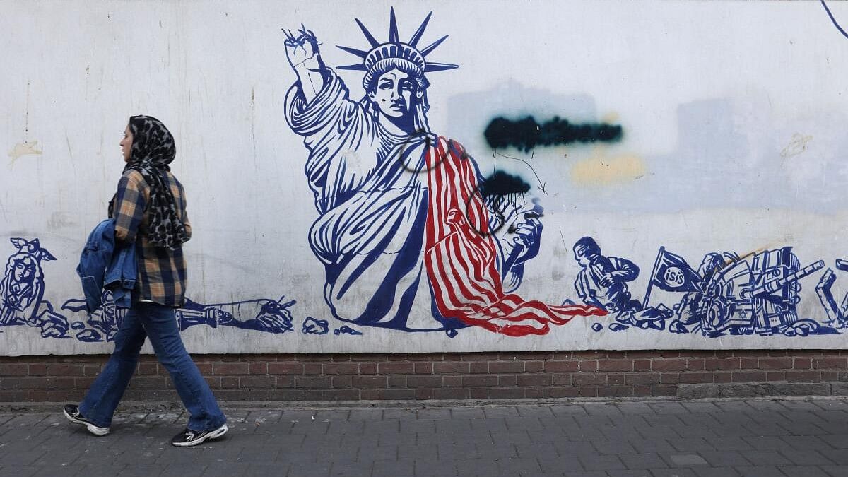 <div class="paragraphs"><p>An Iranian woman passes in front of an anti-US mural on a street in Tehran.</p></div>