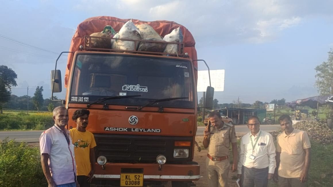 <div class="paragraphs"><p>Environment officers and police seize with a truck seized off Mulehole checkpost near Gundlupet, Chamarajanagar, on Monday.</p></div>