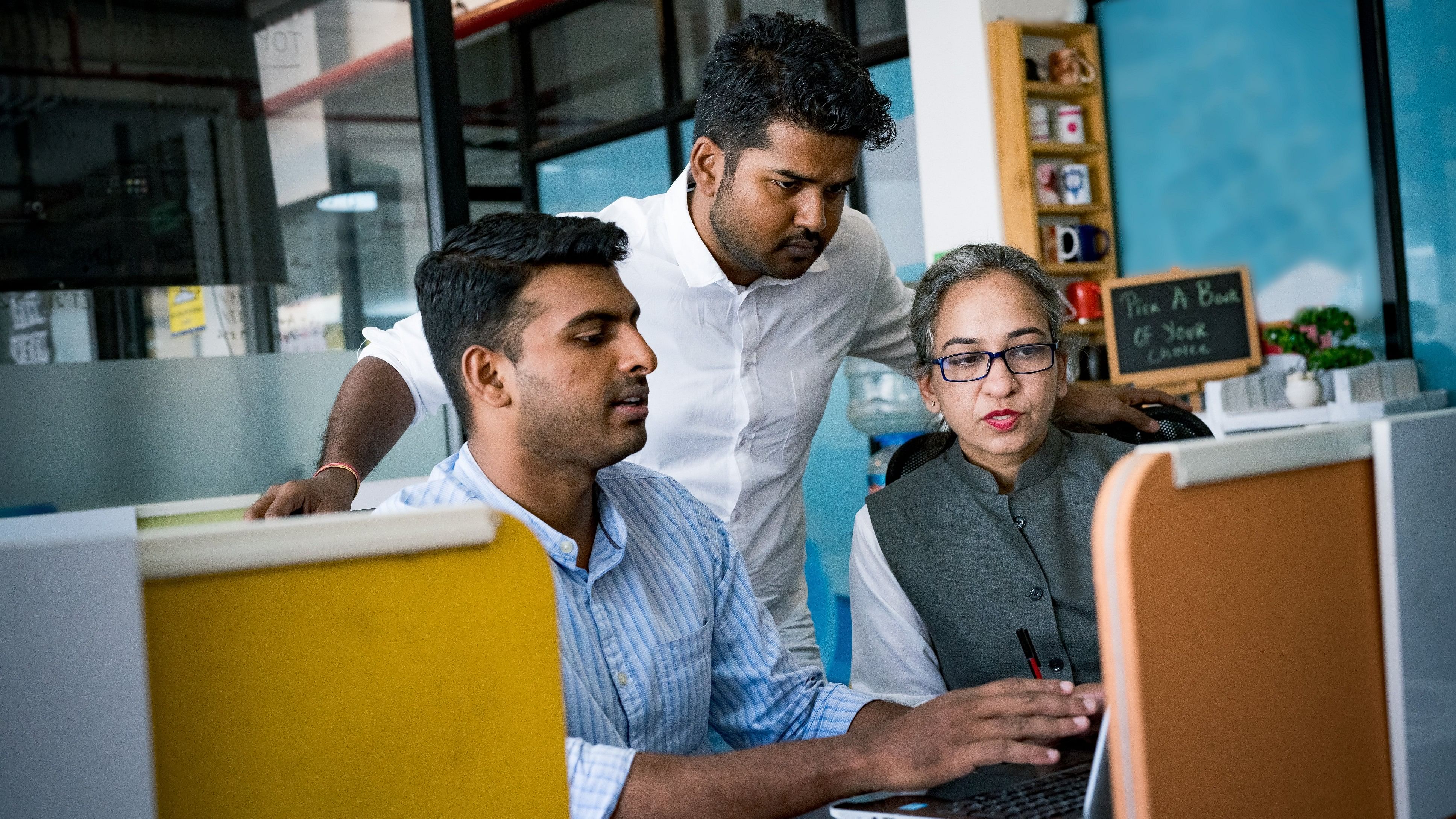 Indian professionals working at a desk at a corporate office.
Global Indian Business Office Lifestyle