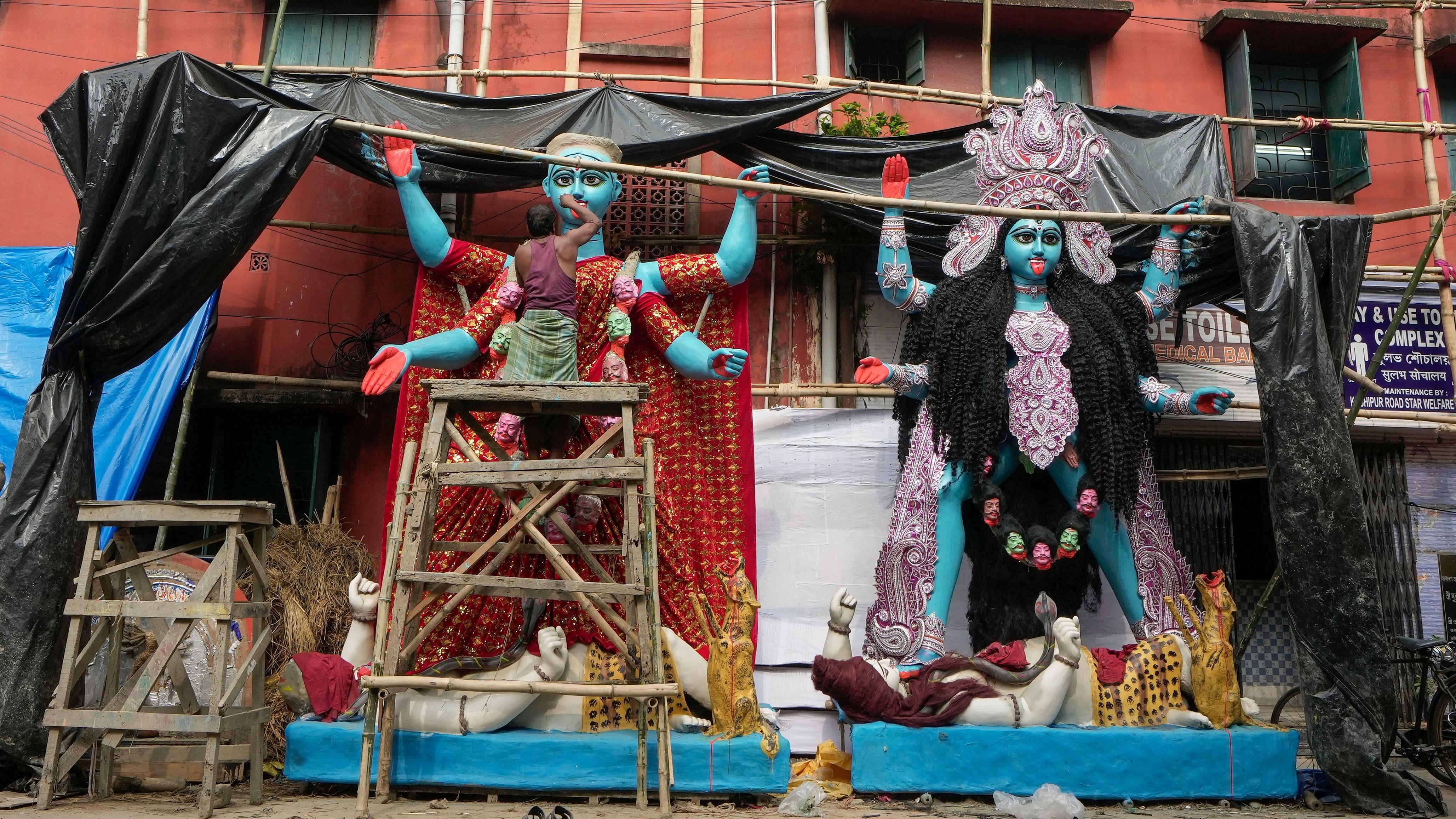 <div class="paragraphs"><p> An artist gives a finishing touch to a goddess Kali idol ahead of the Kali Puja, in Kolkata, West Bengal. </p></div>