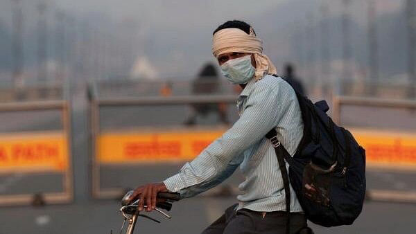 <div class="paragraphs"><p>A man wearing a face mask rides a bicycle as air quality continues to remain poor, a day after Diwali festival celebrations, in New Delhi.</p></div>