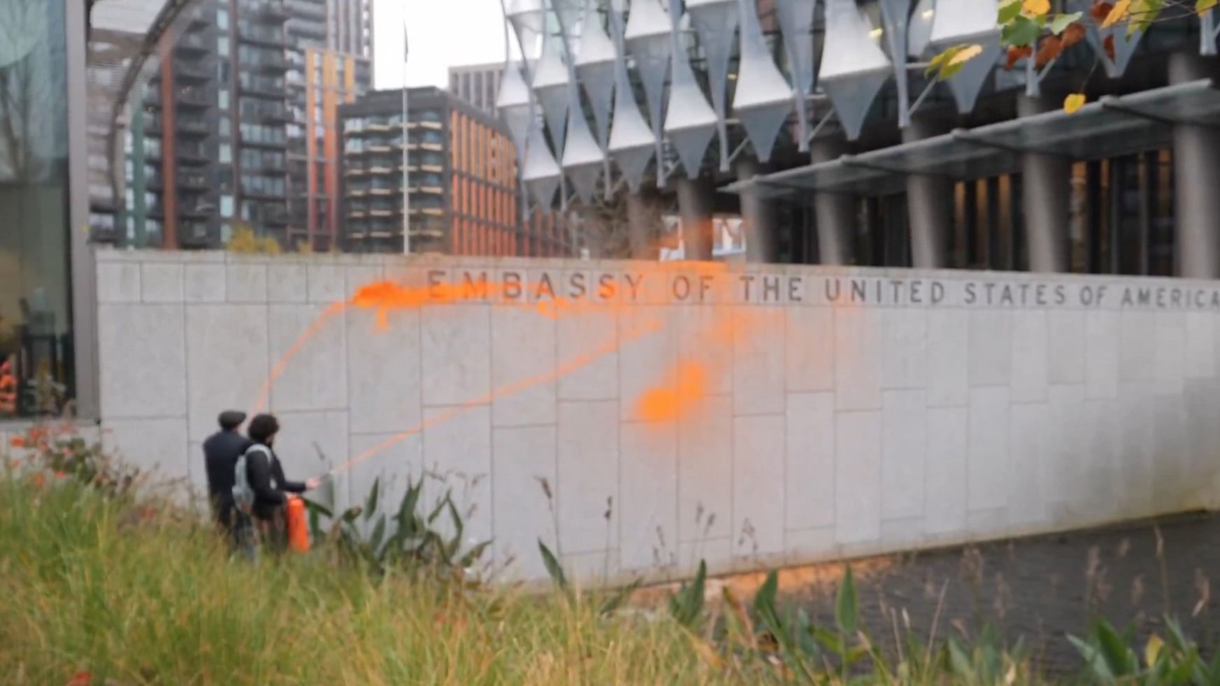 <div class="paragraphs"><p>Two campaigners from Just Stop Oil sprayed the embassy's compound wall with orange paint, a video posted by the group on X showed.</p></div>