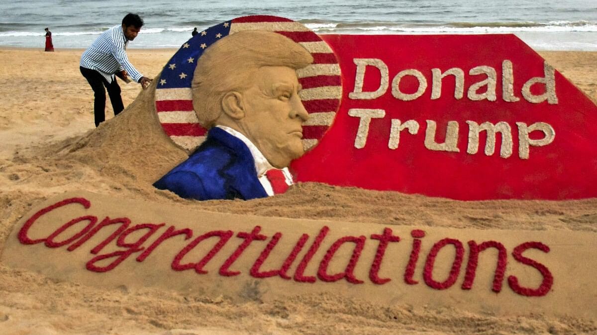 <div class="paragraphs"><p>Sand artist Sudarsan Pattnaik creates a sand sculpture to congratulate Donald Trump for winning the US presidential election, at Puri beach in Odisha, Wednesday, November 6, 2024.</p></div>