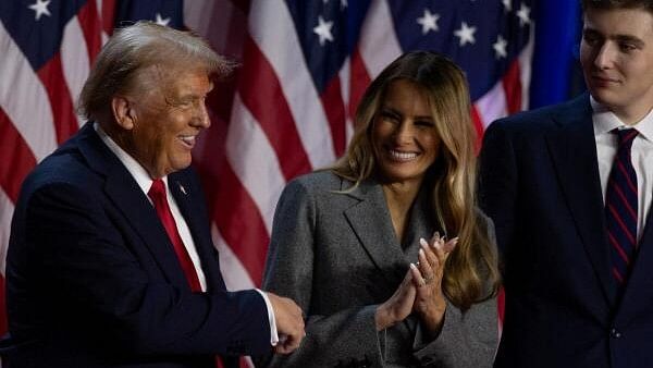 <div class="paragraphs"><p>Republican presidential nominee and former U.S. President Donald Trump reacts next to his wife Melania Trump and son Barron Trump, during his rally for the 2024 U.S. Presidential Election, in Palm Beach County Convention Center, in West Palm Beach, Florida.</p></div>