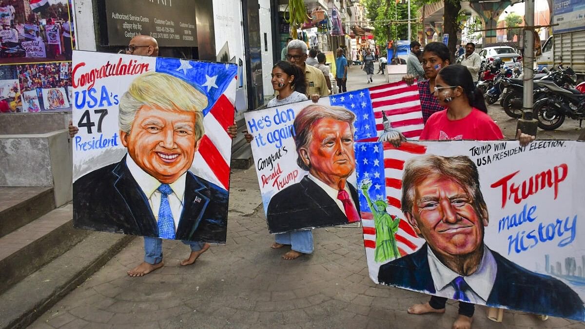 <div class="paragraphs"><p>Students of Gurukul School of Art show painted portraits of Donald Trump as they greet him on his victory in the US Presidential election, at Lalbaug in Mumbai, Wednesday, November 6, 2024.</p></div>