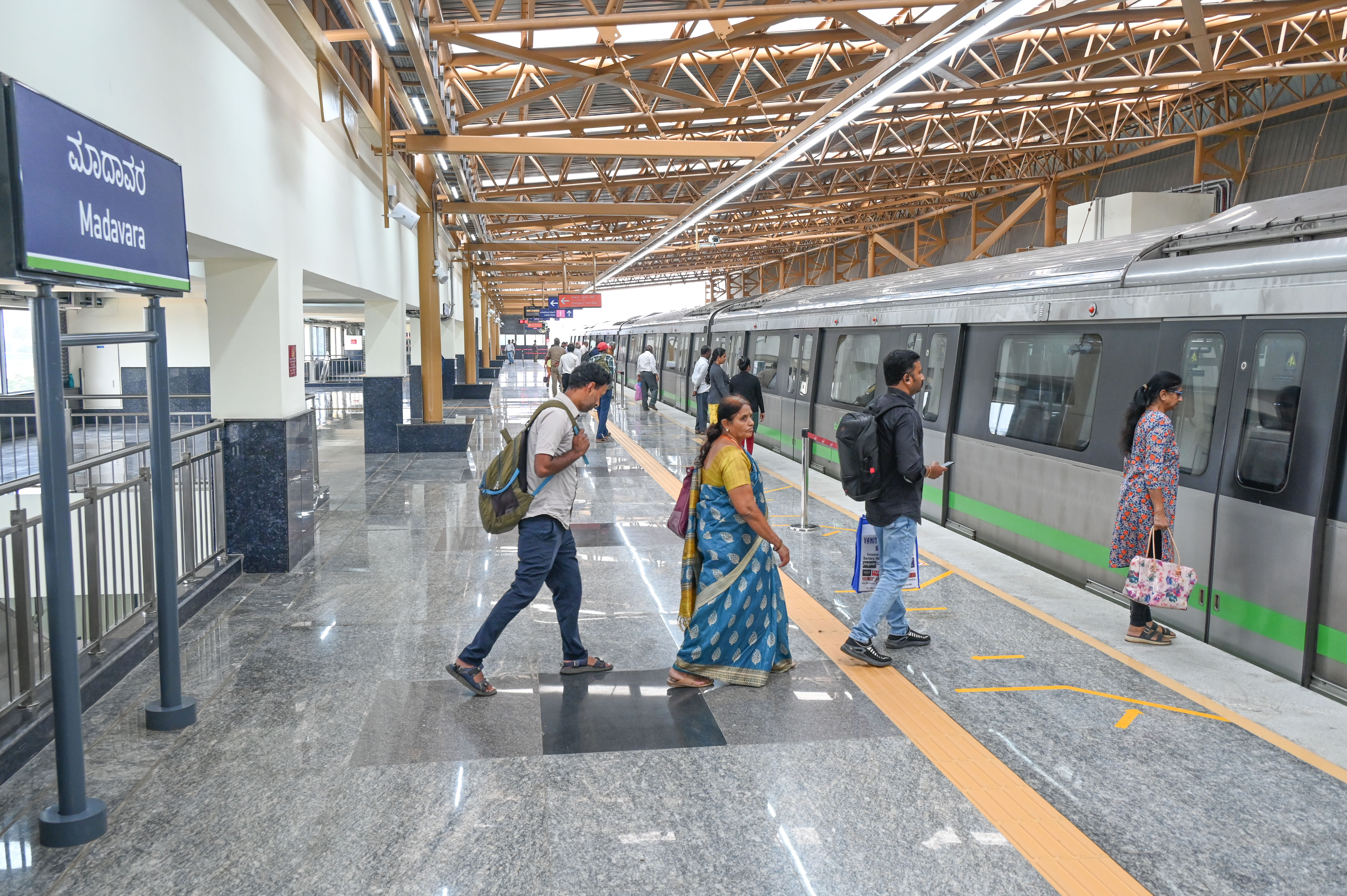 <div class="paragraphs"><p>Passengers board the metro train at the Madavara station on Thursday.&nbsp;</p></div>