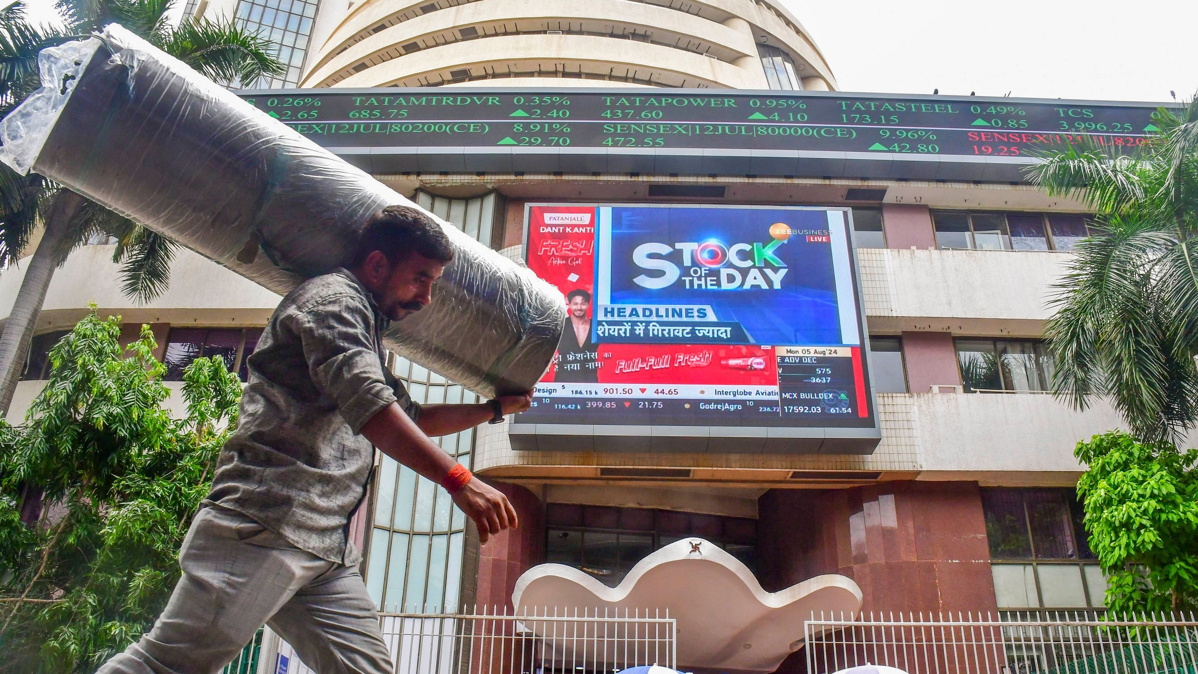 <div class="paragraphs"><p> People walk past the Bombay Stock Exchange building.&nbsp;</p></div>