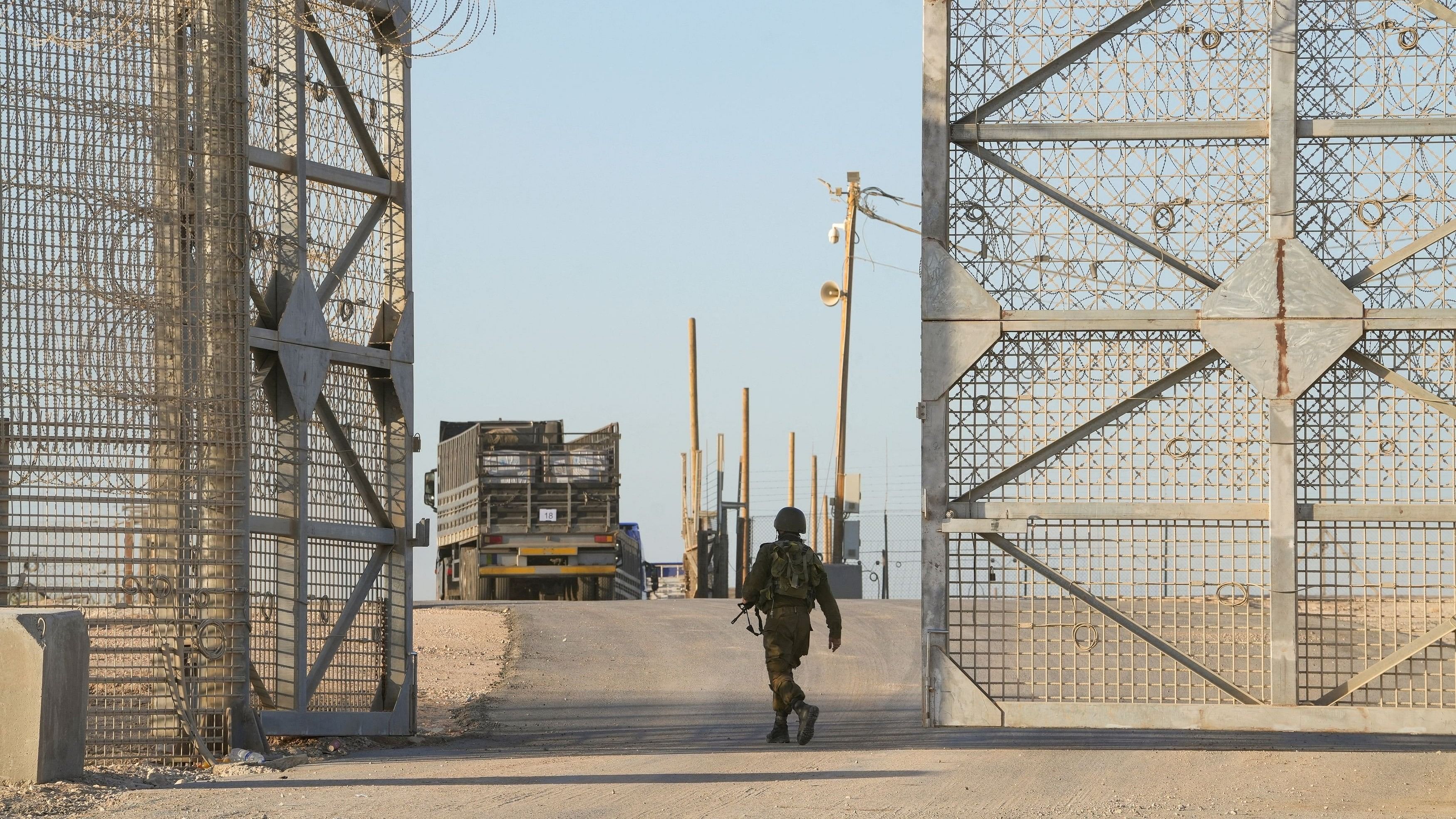 <div class="paragraphs"><p>An Israeli soldier walks near a truck, as trucks carrying humanitarian aid make their way to the Gaza Strip, amid the ongoing conflict in Gaza between Israel and Hamas.</p></div>