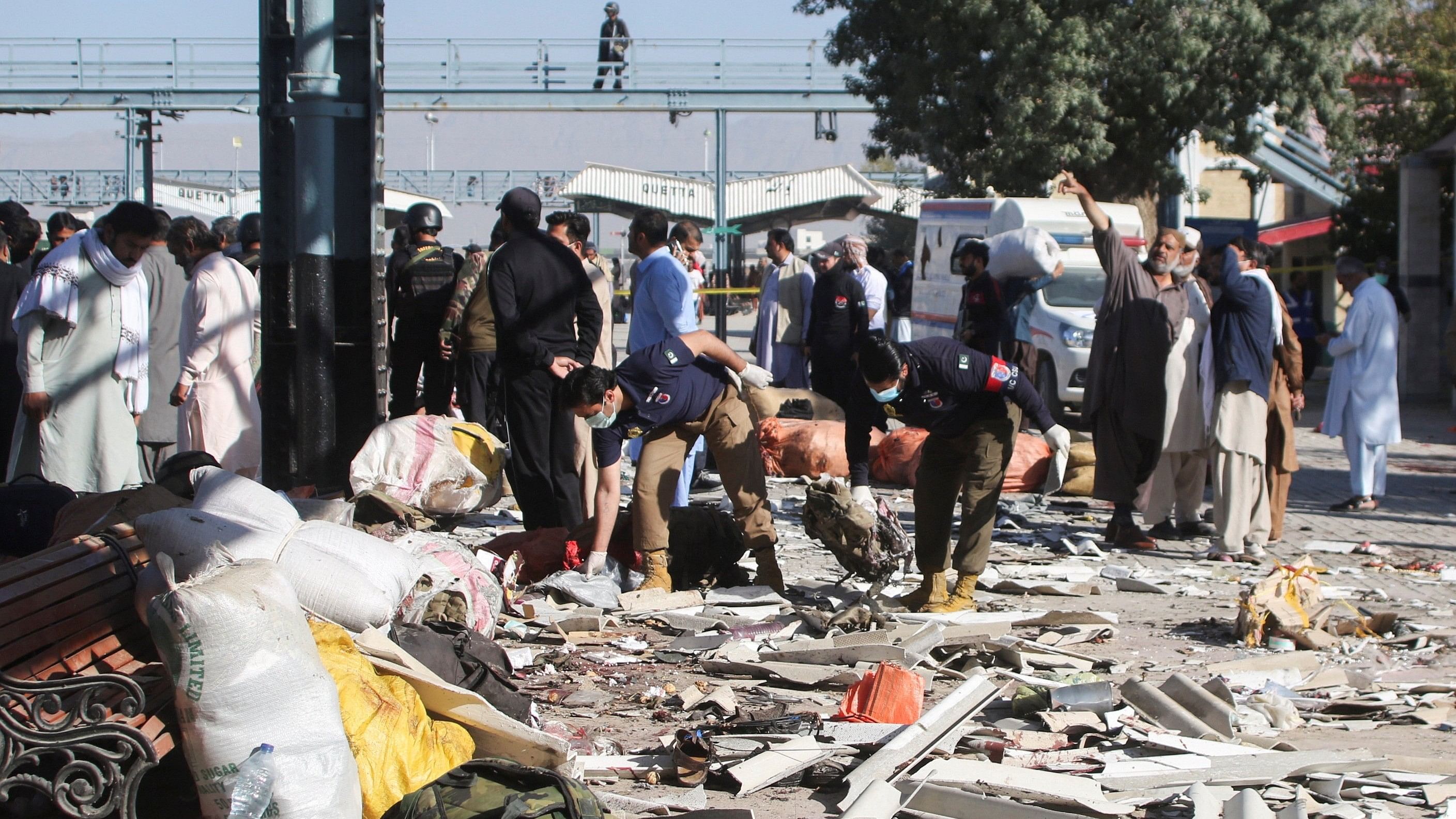 <div class="paragraphs"><p>Police officers collect evidence amid the debris after a bomb blast at a railway station in Quetta, Pakistan November 9, 2024. </p></div>