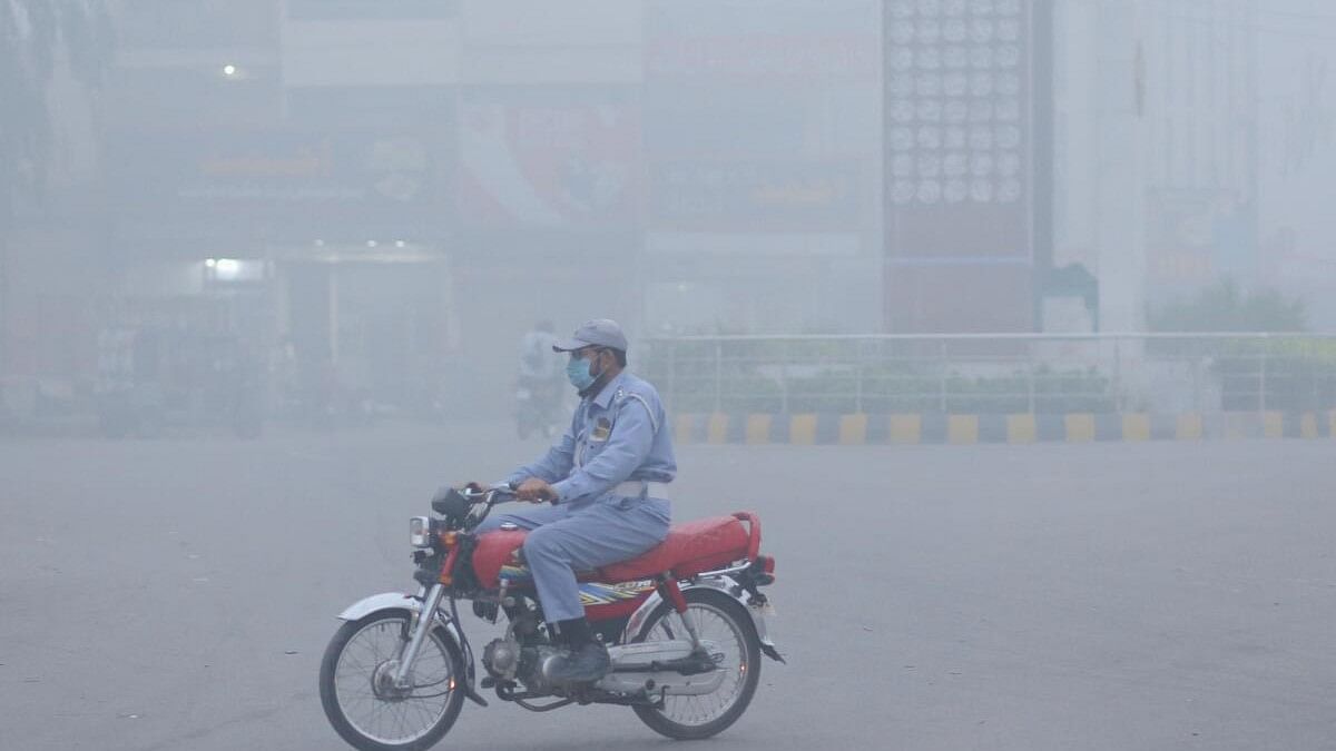 <div class="paragraphs"><p>A police officer wears a mask to avoid smog while riding on a motorbike along a road in Multan.</p><p></p></div>