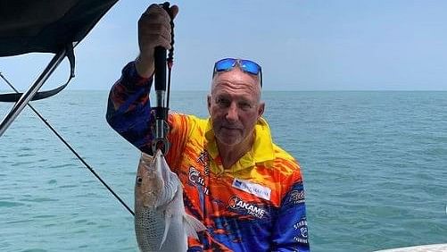 <div class="paragraphs"><p>Ian Botham poses with a fish after being rescued by&nbsp;Merv Hughes following his fall&nbsp;into a crocodile-infested river in Australia's Northern Territory.</p></div>