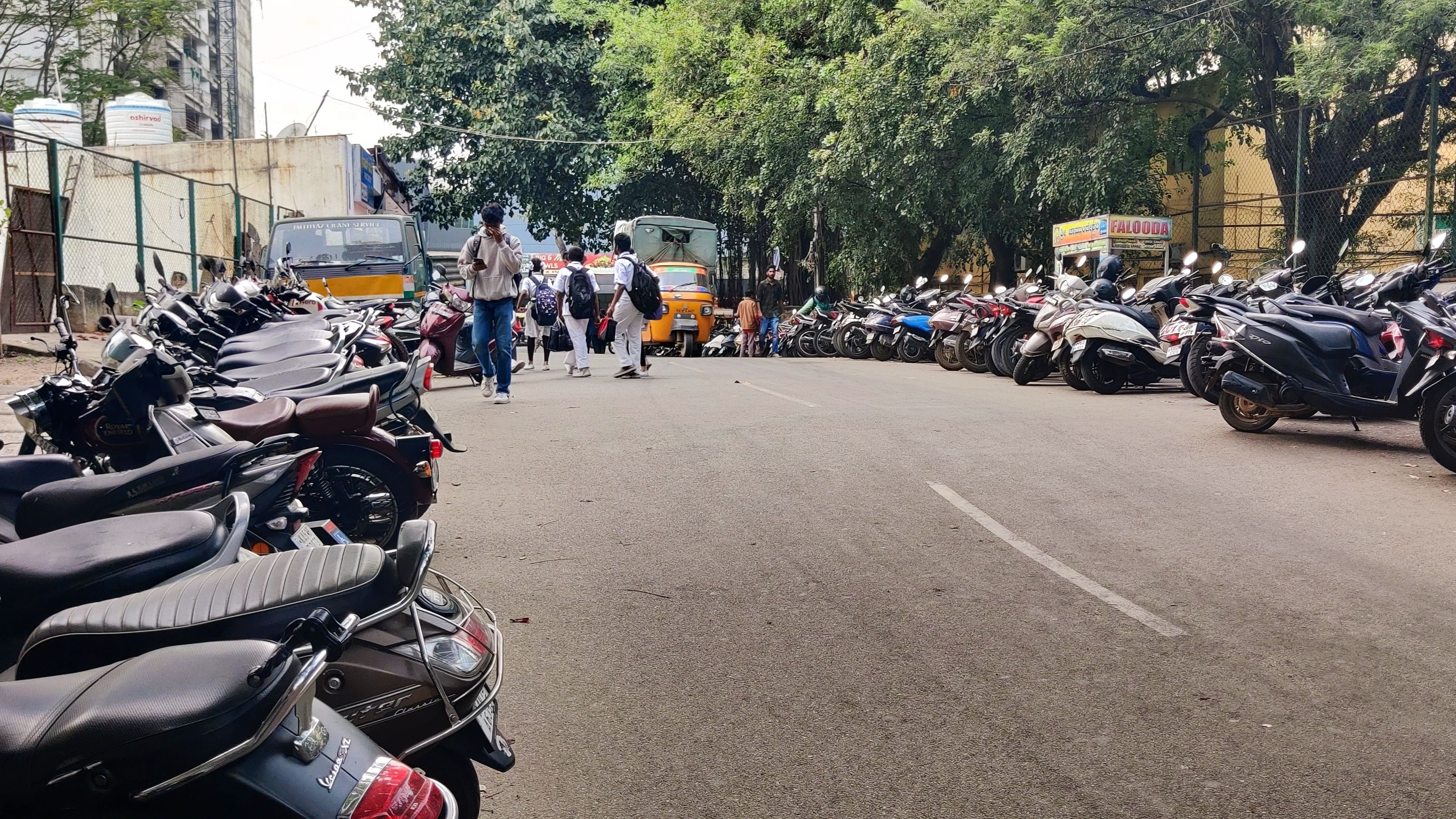 <div class="paragraphs"><p>Vehicles of metro commuters parked on both sides of the road near the Sampige Road metro station. </p></div>