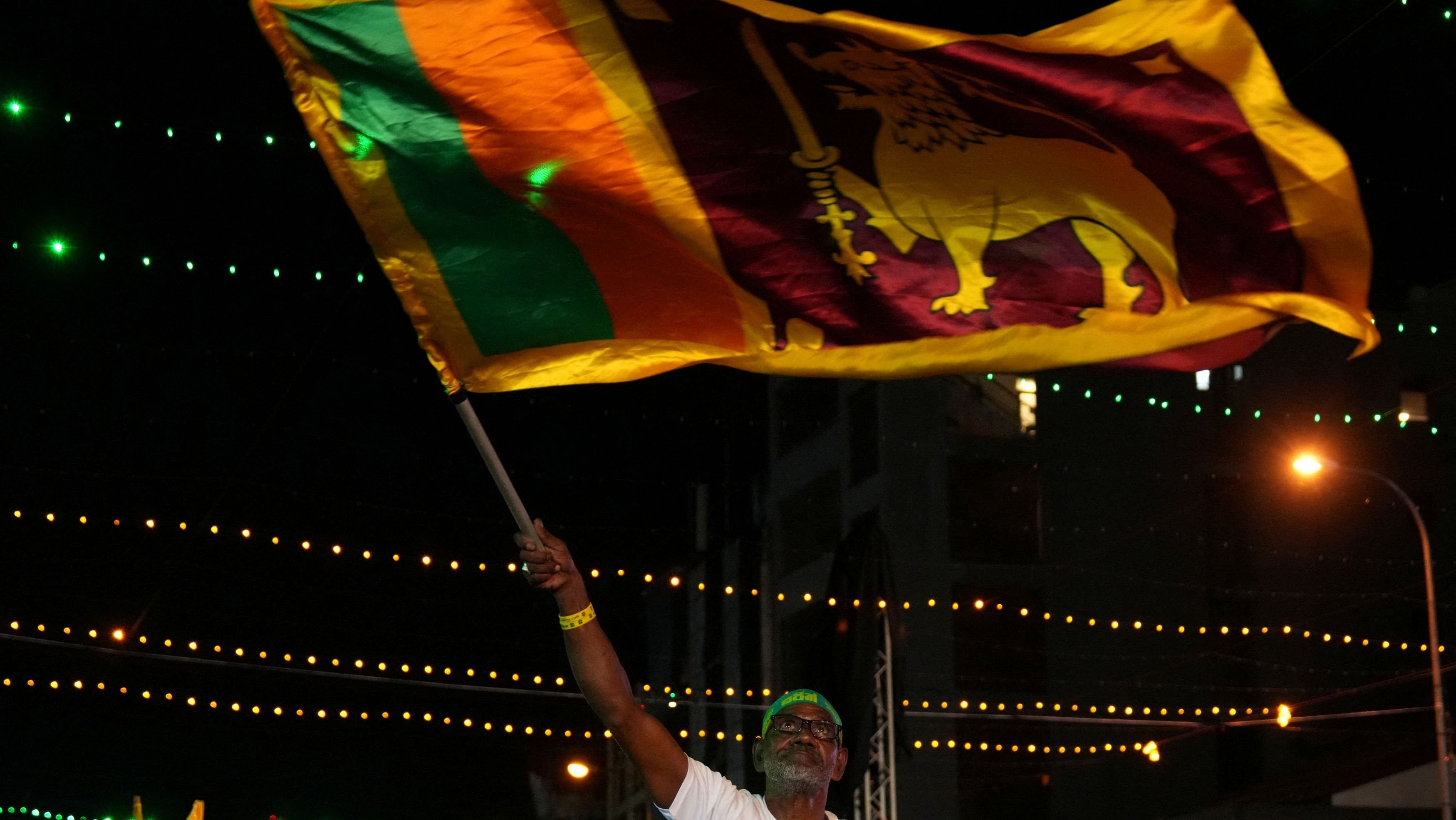 <div class="paragraphs"><p>A man waving Sri Lanka's national flag </p></div>