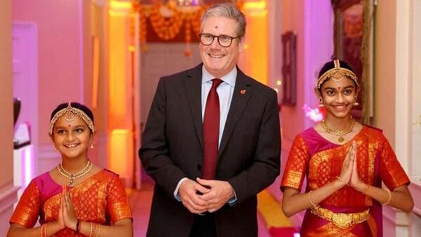 <div class="paragraphs"><p>Britain's Prime Minister Keir Starmer, flanked by members of the ​﻿​Arunima Kumar Dance Company, attends a reception at 10 Downing Street to celebrate Diwali in London, Britain.&nbsp;</p></div>